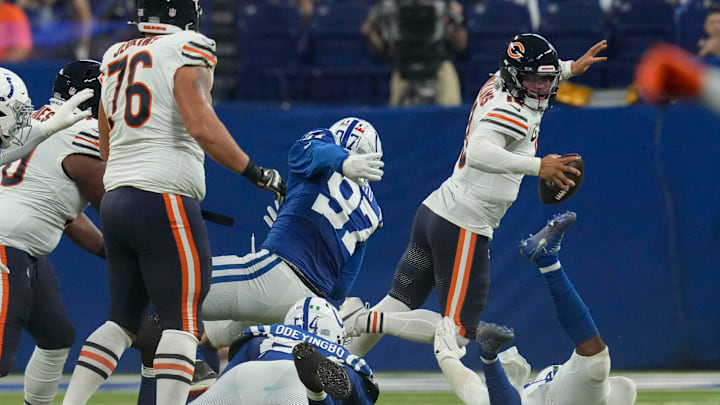 Chicago Bears quarterback Caleb Williams (18) jumps over Indianapolis Colts linebacker Zaire Franklin (44) while evading tackle Sunday, Sept. 22, 2024, during a game at Lucas Oil Stadium in Indianapolis.