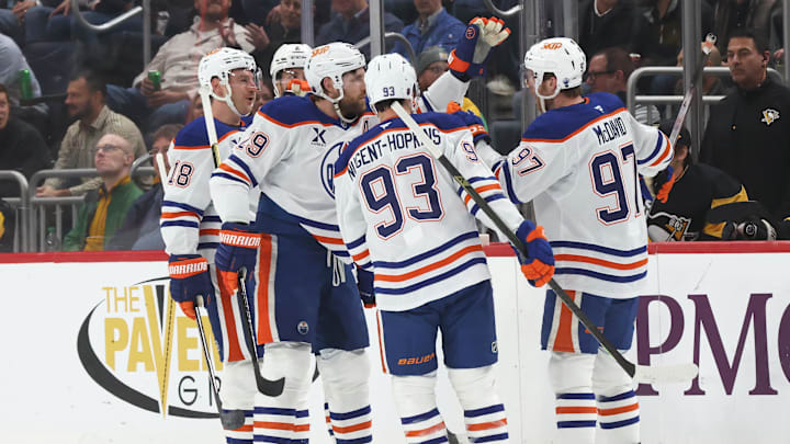 Dec 16, 2025; Pittsburgh, Pennsylvania, USA; Edmonton Oilers center Connor McDavid (97) is congratulated by teammates after scoring a goal against the Pittsburgh Penguins during the first period at PPG Paints Arena. Mandatory Credit: Charles LeClaire-Imagn Images Dec 16, 2025; Pittsburgh, Pennsylvania, USA; Edmonton Oilers center Connor McDavid (97) is congratulated by teammates after scoring a goal against the Pittsburgh Penguins during the first period at PPG Paints Arena. Mandatory Credit: Charles LeClaire-Imagn Images
