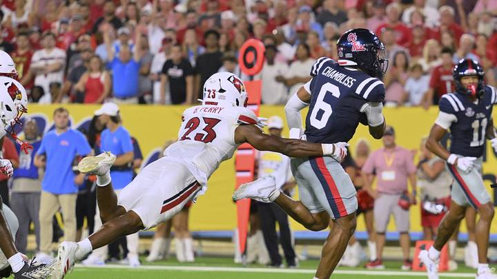 Sep 6, 2026; Nashville, Tennessee, USA; Mississippi Rebels quarterback Trinidad Chambliss (6) carries the ball for a touchdown as Louisville Cardinals linebacker Benjamin Perry (23) defends during the fourth quarter at Nissan Stadium. Mandatory Credit: Steve Roberts-Imagn Images Sep 6, 2026; Nashville, Tennessee, USA; Mississippi Rebels quarterback Trinidad Chambliss (6) carries the ball for a touchdown as Louisville Cardinals linebacker Benjamin Perry (23) defends during the fourth quarter at Nissan Stadium. Mandatory Credit: Steve Roberts-Imagn Images
