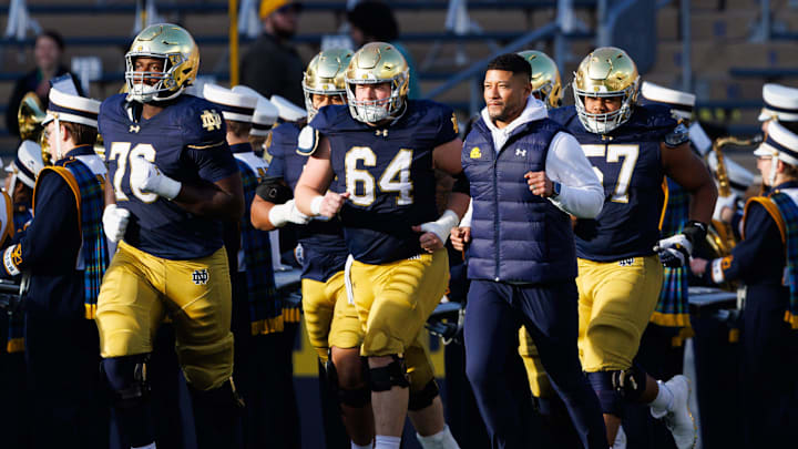 Notre Dame head coach Marcus Freeman takes the field with his players before a NCAA football game against Syracuse at Notre Dame Stadium on Saturday, Nov. 22, 2025, in South Bend.