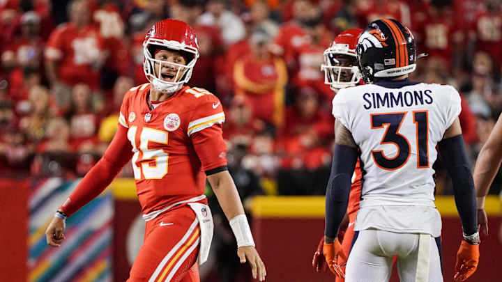 Oct 12, 2023; Kansas City, Missouri, USA; Kansas City Chiefs quarterback Patrick Mahomes (15) speaks to Denver Broncos safety Justin Simmons (31) after a play during the first half at GEHA Field at Arrowhead Stadium. Mandatory Credit: Denny Medley-Imagn Images