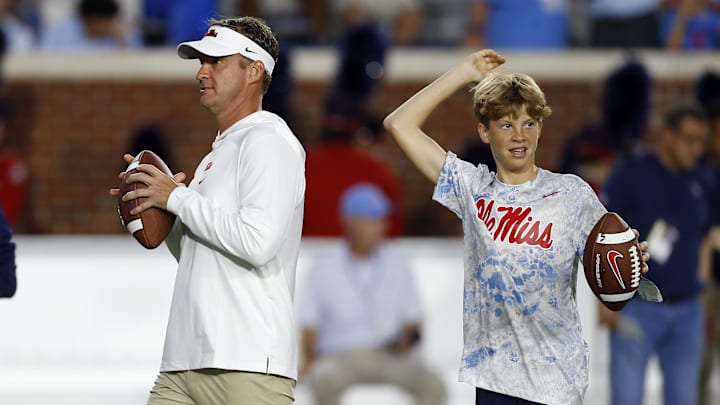 Oct 28, 2023; Oxford, Mississippi, USA; Mississippi Rebels head coach Lane Kiffin (left) and his son Knox Kiffin during warm ups prior to a game against the Vanderbilt Commodores at Vaught-Hemingway Stadium. Mandatory Credit: Petre Thomas-Imagn Images