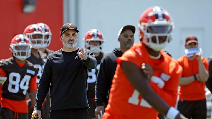 Cleveland Browns coach Kevin Stefanski watches quarterback Shedeur Sanders (12) participate in drills during day two of NFL rookie minicamp at the Cleveland Browns training facility May 10, 2025, in Berea, Ohio.