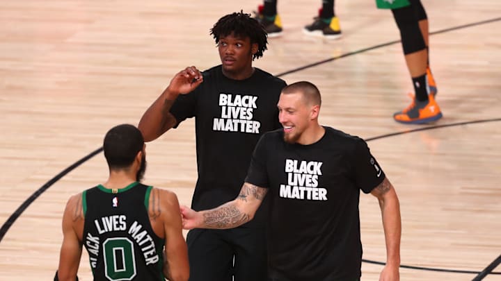Sep 11, 2020; Lake Buena Vista, Florida, USA; Boston Celtics forward Jayson Tatum (0) celebrates with center Robert Williams III (middle) and center Daniel Theis (right) after defeating the Toronto Raptors in game seven of the second round of the 2020 NBA Playoffs at ESPN Wide World of Sports Complex. Mandatory Credit: Kim Klement-Imagn Images