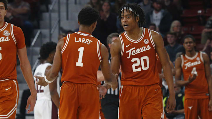 Mar 4, 2025; Starkville, Mississippi, USA; Texas Longhorns guard Tre Johnson (20) reacts with guard Julian Larry (1) during the second half against the Mississippi State Bulldogs at Humphrey Coliseum. Mandatory Credit: Petre Thomas-Imagn Images