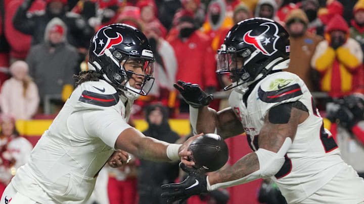 Jan 18, 2025; Kansas City, Missouri, USA; Houston Texans quarterback C.J. Stroud (7) hands off to running back Joe Mixon (28) against the Kansas City Chiefs during the second half of a 2025 AFC divisional round game at GEHA Field at Arrowhead Stadium. Mandatory Credit: Denny Medley-Imagn Images