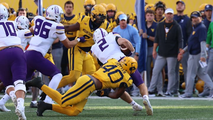 West Virginia University linebacker Josiah Trotter tackles University at Albany running back Griffin Woodell.