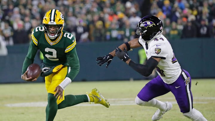 Green Bay Packers quarterback Malik Willis (2) breaks away from Baltimore Ravens cornerback Marlon Humphrey (44) to score a touchdown in the second quarter at Lambeau Field in Green Bay, Wisconsin. 