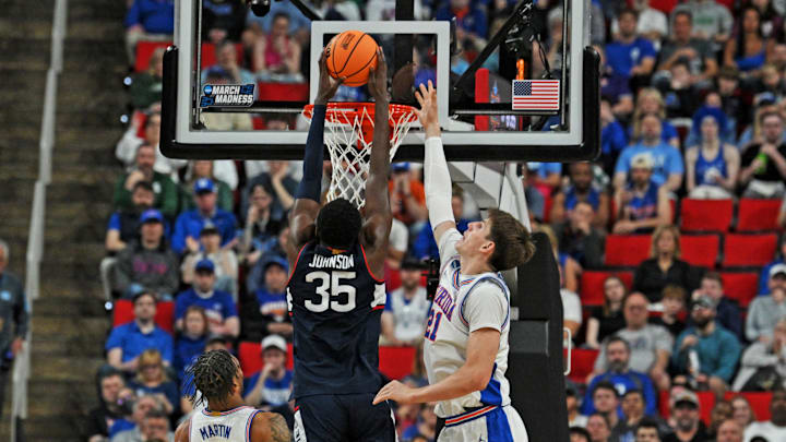 Mar 23, 2025; Raleigh, NC, USA; Connecticut Huskies center Samson Johnson (35) drives to the basket as Florida Gators forward Alex Condon (21) defends during the second half in the second round of the NCAA Tournament at Lenovo Center. Mandatory Credit: Zachary Taft-Imagn Images Mar 23, 2025; Raleigh, NC, USA; Connecticut Huskies center Samson Johnson (35) drives to the basket as Florida Gators forward Alex Condon (21) defends during the second half in the second round of the NCAA Tournament at Lenovo Center. Mandatory Credit: Zachary Taft-Imagn Images