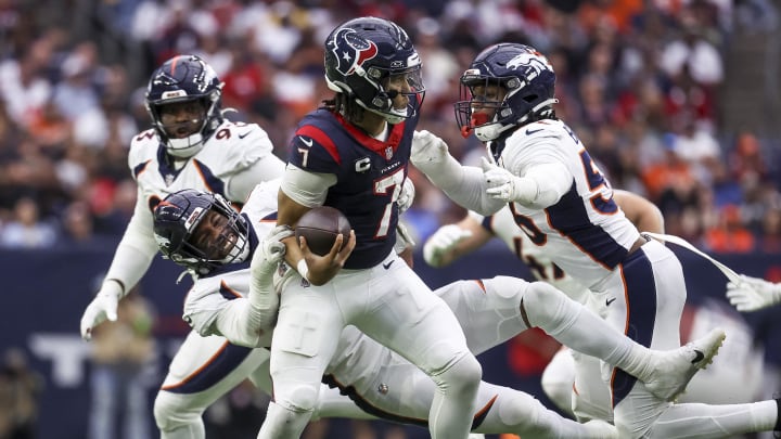 Dec 3, 2023; Houston, Texas, USA; Denver Broncos linebacker Jonathon Cooper (0) and linebacker Baron Browning (56) attempt to tackle Houston Texans quarterback C.J. Stroud (7) during the third quarter at NRG Stadium. Mandatory Credit: Troy Taormina-USA TODAY Sports