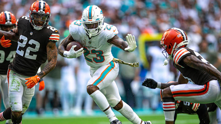 Miami Dolphins running back Jeff Wilson Jr. (23), shows a memorable stiff arm move against Cleveland
