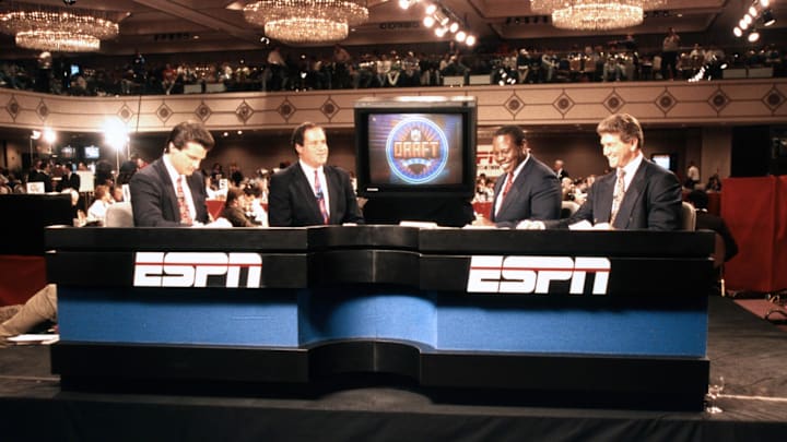 April 1992; New York, NY, USA; ESPN announcers Mel Kiper Jr. (left) Chris Berman (second from left), Tom Jackson (second from right), and Joe Theismann during the 1992 NFL Draft at the New York Marriott Marquis. FILE PHOTO; Mandatory Credit: Imagn Images April 1992; New York, NY, USA; ESPN announcers Mel Kiper Jr. (left) Chris Berman (second from left), Tom Jackson (second from right), and Joe Theismann during the 1992 NFL Draft at the New York Marriott Marquis. FILE PHOTO; Mandatory Credit: Imagn Images