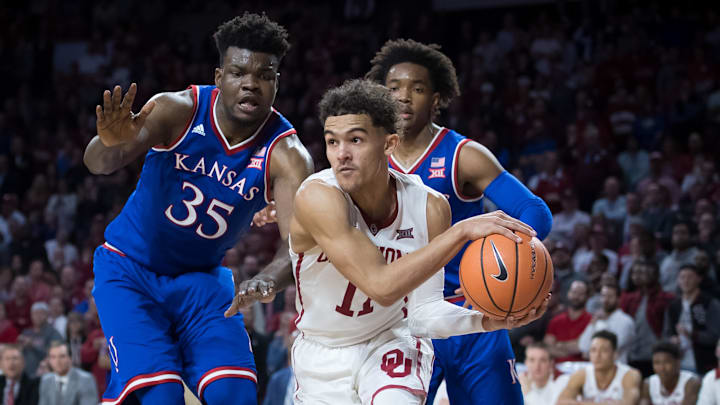 Jan 23, 2018; Norman, OK, USA; Oklahoma Sooners guard Trae Young (11) looks to pass the ball defended by Kansas Jayhawks center Udoka Azubuike (35) during the second half at Lloyd Noble Center. Mandatory Credit: Rob Ferguson-Imagn Images