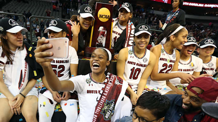 South Carolina basketball star Kaela Davis posing with the national championship trophy
