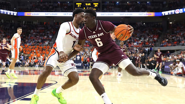 Texas A&M Aggies guard Ali Dibba (6) drives to the basket as Auburn Tigers guard Kevin Overton (1) defends during the first half at Neville Arena. Mandatory Credit: John Reed-Imagn Images