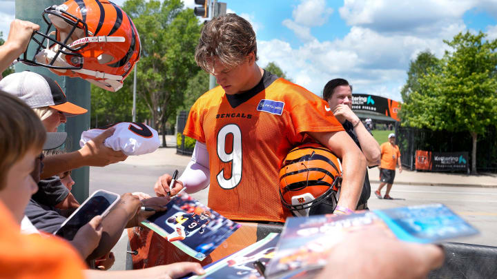 Bengals quarterback Joe Burrow signs autographs after OTAs Tuesday, May 28, 2024 at the Kettering Health Practice Fields outside of Paycor Stadium. Burrow along with several other Bengals players signed jerseys, footballs and other items for fans as they waited for the players to exit the practice field. Bengals quarterback Joe Burrow signs autographs after OTAs Tuesday, May 28, 2024 at the Kettering Health Practice Fields outside of Paycor Stadium. Burrow along with several other Bengals players signed jerseys, footballs and other items for fans as they waited for the players to exit the practice field.