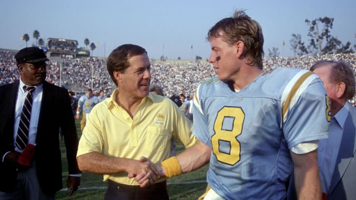Nov 12, 1988; Pasadena, CA, USA; FILE PHOTO; UCLA Bruins quarterback (8) Troy Aikman shakes hands with head coach Terry Donahue at they leave the field following their victory over the Stanford Cardinal 27-17 at the Rose Bowl. Mandatory Credit: Photo By Imagn Images © Copyright  Imagn Images