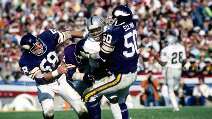 Jan 9, 1977; Pasadena, CA,, USA; FILE PHOTO; Minnesota Vikings linebacker (58) Wally Hilgenberg and (50) Jeff Siemon stop Oakland Raiders receiver (21) Cliff Branch in Super Bowl XI at the Rose Bowl. The Raoders defeated the Vikings 32-14 to win their first Super Bowl title. Mandatory Credit: Photo By Malcolm Emmons- Imagn Images © Copyright Malcolm Emmons