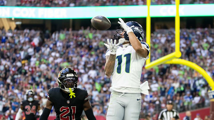 Dec 8, 2024; Glendale, Arizona, USA; Seattle Seahawks wide receiver Jaxon Smith-Njigba (11) catches a touchdown pass against Arizona Cardinals cornerback Garrett Williams (21) in the first half at State Farm Stadium. Mandatory Credit: Mark J. Rebilas-Imagn Images