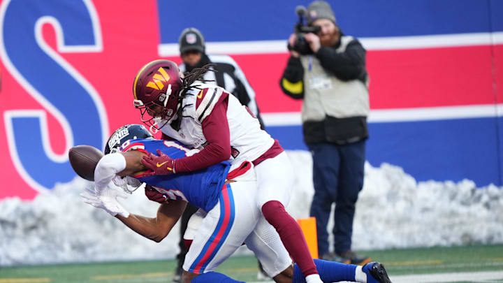 Dec 14, 2025; East Rutherford, New Jersey, USA; New York Giants wide receiver Darius Slayton (18) reaches for the ball against Washington Commanders cornerback Antonio Hamilton Sr. (34) during the fourth quarter at MetLife Stadium. Dec 14, 2025; East Rutherford, New Jersey, USA; New York Giants wide receiver Darius Slayton (18) reaches for the ball against Washington Commanders cornerback Antonio Hamilton Sr. (34) during the fourth quarter at MetLife Stadium.