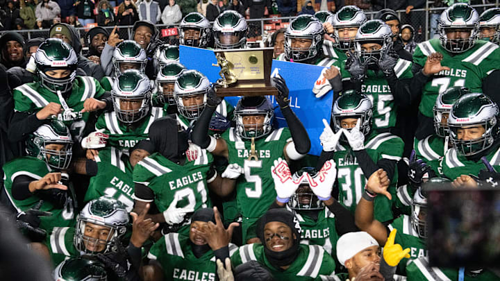 Members of the Winslow Township High School football team celebrate with their trophy after Winslow defeated Phillipsburg, 35-0, in the State Group 4 football final played at SHI Stadium at Rutgers University in Piscataway on Wednesday, December 4, 2024.