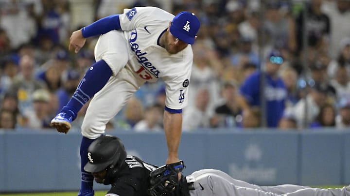 Jul 2, 2025; Los Angeles, California, USA;  Los Angeles Dodgers third baseman Max Muncy (13) flips over Chicago White Sox right fielder Michael A. Taylor (21) after tagging him out on an attempted steal in the fifth inning at Dodger Stadium. Mandatory Credit: Jayne Kamin-Oncea-Imagn Images