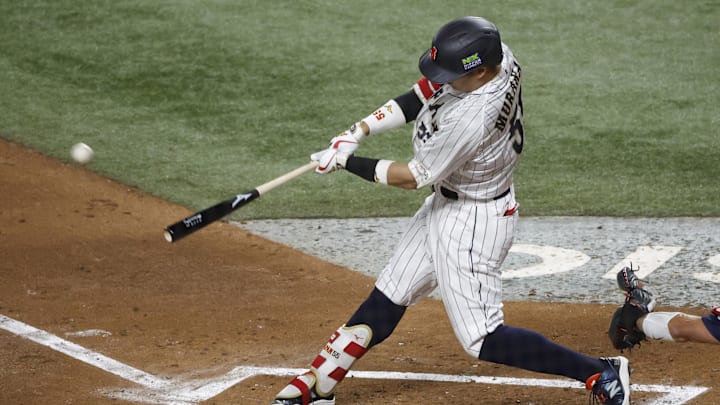 Mar 21, 2023; Miami, Florida, USA; Japan third baseman Munetaka Murakami (55) hits a home run against the USA in the second inning at LoanDepot Park. Mandatory Credit: Rhona Wise-Imagn Images