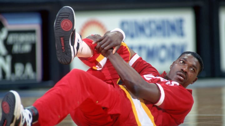 Apr 8, 1990; Orlando, FL, USA; FILE PHOTO; Houston Rockets center #34 HAKEEM OLAJUWON stretches before his game against the Orlando Magic at the Orlando Arena. Mandatory Credit: Photo By USA TODAY Sports (c) Copyright USA TODAY Sports