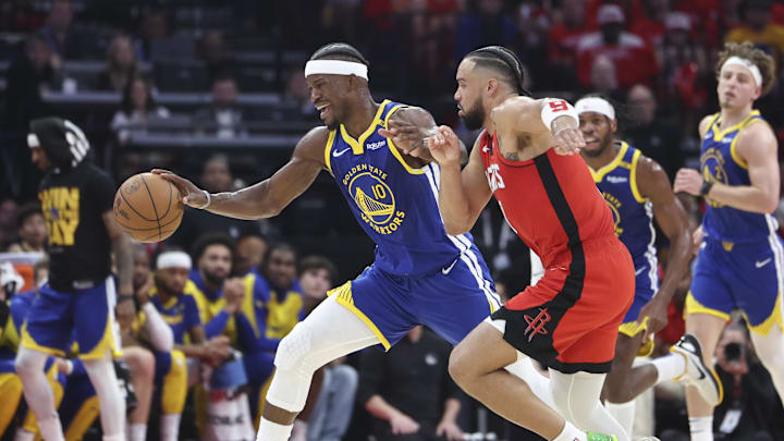 Golden State Warriors forward Jimmy Butler III controls the ball as Houston Rockets forward Dillon Brooks defends.