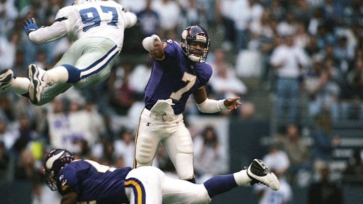Nov 26, 1998; Irving, TX, USA; FILE PHOTO; Minnesota Vikings quarterback Randall Cunningham (7) is pressured as he releases the ball by Dallas Cowboys defensive end Kavita Pittman (97) during the 1998 season at Texas Stadium. Mandatory Credit: RVR Photos-Imagn Images