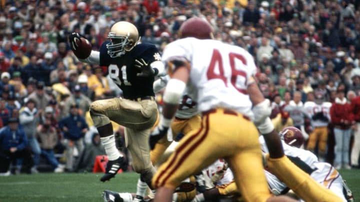 Oct 24, 1987, South Bend, IN, USA; FILE PHOTO; Notre Dame Fighting Irish receiver Tim Brown (81) returns a punt against the Southern California Trojans at Notre Dame Stadium during the 1987 season. Mandatory Credit: Malcolm Emmons-Imagn Images Oct 24, 1987, South Bend, IN, USA; FILE PHOTO; Notre Dame Fighting Irish receiver Tim Brown (81) returns a punt against the Southern California Trojans at Notre Dame Stadium during the 1987 season. Mandatory Credit: Malcolm Emmons-Imagn Images