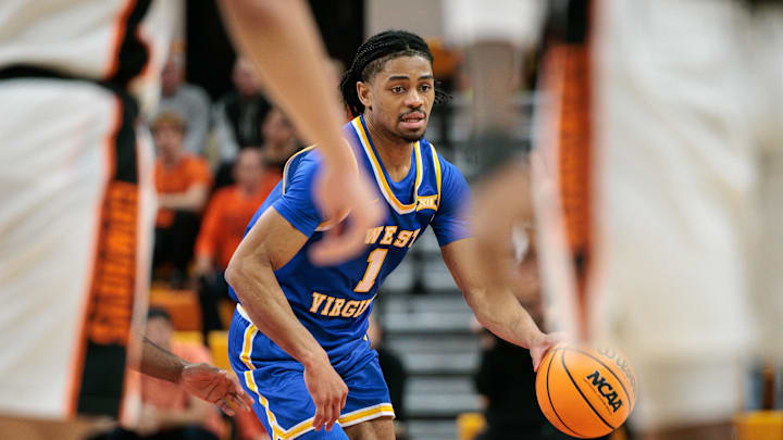 Feb 24, 2026; Stillwater, Oklahoma, USA; West Virginia Mountaineers guard Jasper Floyd (1) dribbles during overtime against the Oklahoma State Cowboys at Gallagher-Iba Arena. Mandatory Credit: William Purnell-Imagn Images