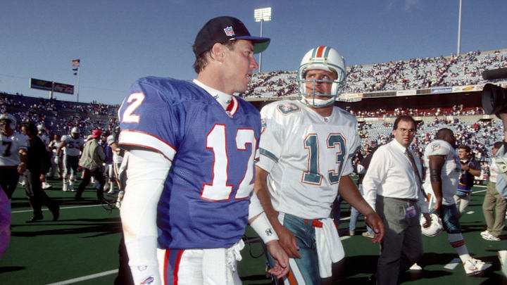 Oct 4, 1992; Orchard Park, NY, USA; FILE PHOTO; Buffalo Bills quarterback (12) Jim Kelly and Miami Dolphins quarterback Dan Marino (13) leave the field after the Dolphins defeated the Bills 37-10 at Rich Stadium. 