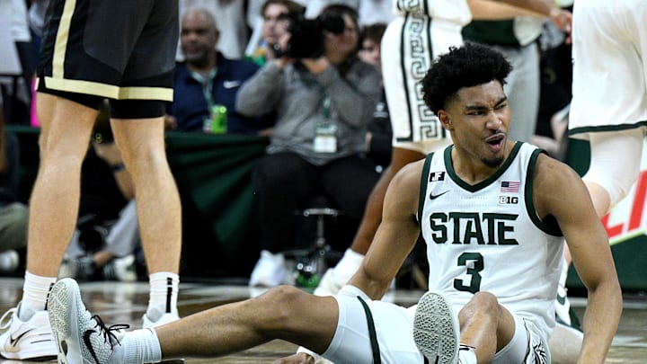 Feb 18, 2025; East Lansing, Michigan, USA;  Michigan State Spartans guard Jaden Akins (3) celebrates after a Purdue Boilermakers foul that knocked him to the floor during the second half at Jack Breslin Student Events Center. Mandatory Credit: Dale Young-Imagn Images