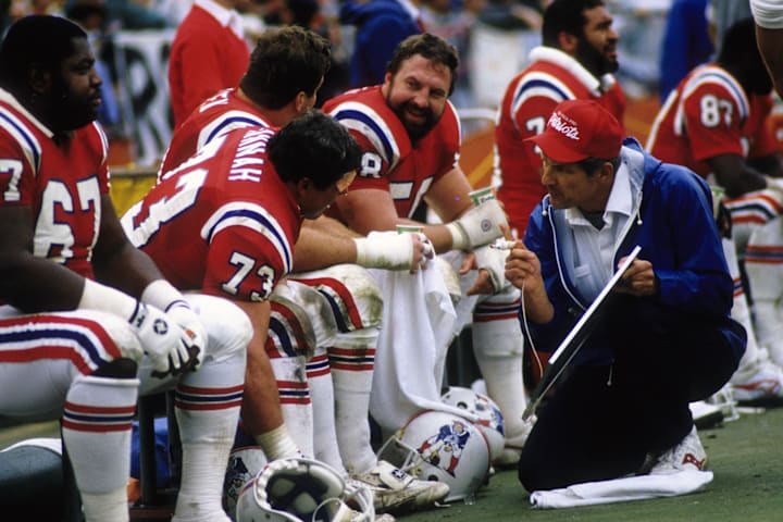 Jan 12, 1986; Miami, FL, USA; FILE PHOTO; A New England Patriots assistant coach talks with guard John Hannah (73) during the Jan 12, 1986; Miami, FL, USA; FILE PHOTO; A New England Patriots assistant coach talks with guard John Hannah (73) during the