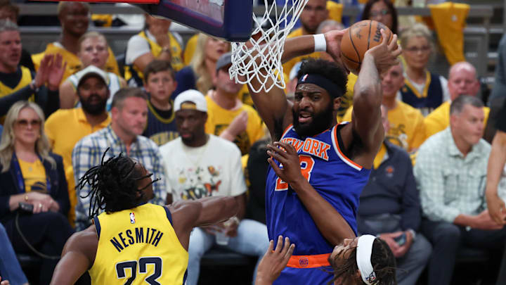 May 31, 2025; Indianapolis, Indiana, USA; New York Knicks center Mitchell Robinson (23) has the ball defended by Indiana Pacers forward Aaron Nesmith (23) and center Myles Turner (33) in the first quarter during game six of the eastern conference finals for the 2025 NBA Playoffs at Gainbridge Fieldhouse. Mandatory Credit: Trevor Ruszkowski-Imagn Images