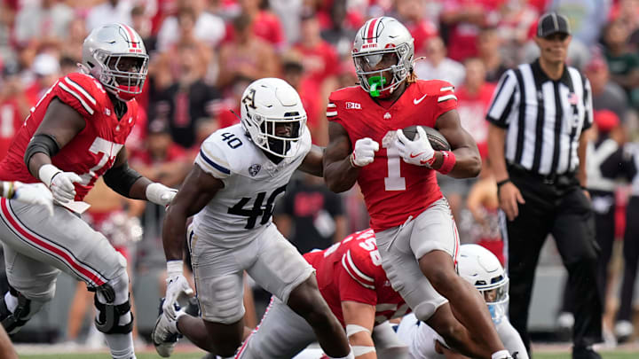 Aug 31, 2024; Columbus, OH, USA; Ohio State Buckeyes running back Quinshon Judkins (1) runs past Akron Zips linebacker Bryan McCoy (40) during the first half of the NCAA football game at Ohio Stadium.