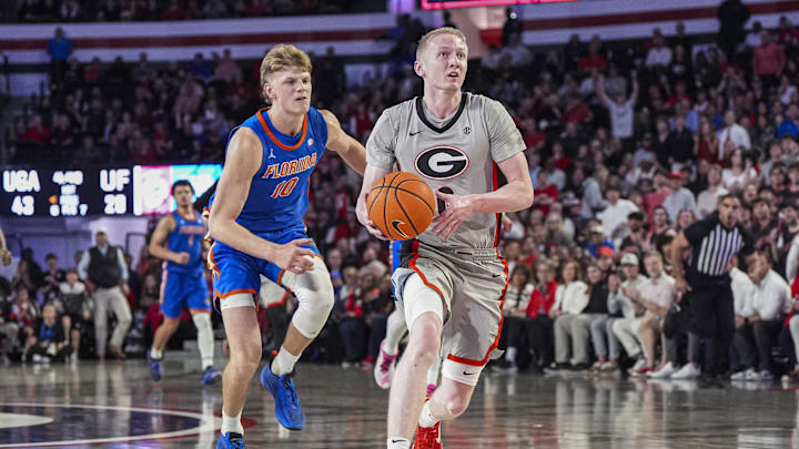Feb 25, 2025; Athens, Georgia, USA; Georgia Bulldogs guard Blue Cain (0) breaks to the basket behind Florida Gators forward Thomas Haugh (10) during the first half at Stegeman Coliseum. Mandatory Credit: Dale Zanine-Imagn Images