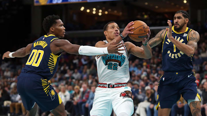 Dec 1, 2024; Memphis, Tennessee, USA; Memphis Grizzlies guard Desmond Bane (22) drives to the basket between Indiana Pacers guard Bennedict Mathurin (00) and forward Obi Toppin (1) during the second quarter at FedExForum. Mandatory Credit: Petre Thomas-Imagn Images