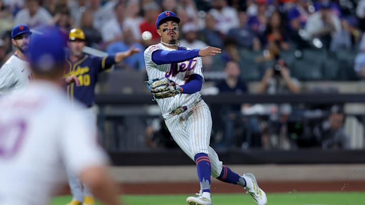 Jul 3, 2025; New York City, New York, USA; New York Mets third baseman Mark Vientos (27) throws to first on an RBI infield single by Milwaukee Brewers third baseman Caleb Durbin (not pictured) during the fourth inning at Citi Field. Mandatory Credit: Brad Penner-Imagn Images