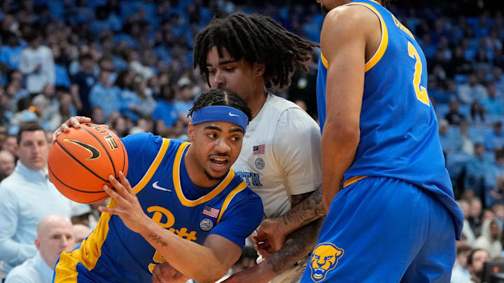 Feb 8, 2025; Chapel Hill, North Carolina, USA;  Pittsburgh Panthers guard Ishmael Leggett (5) with the ball as North Carolina Tar Heels guard Elliot Cadeau (3) defends in the first half at Dean E. Smith Center. Mandatory Credit: Bob Donnan-Imagn Images
