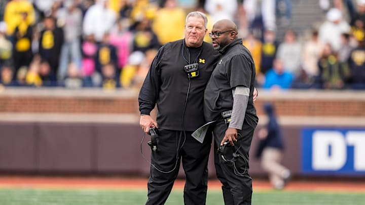 Michigan associate head coach Biff Poggi, left, talks to running backs coach Tony Alford during the second half of the spring game at Michigan Stadium in Ann Arbor on Saturday, April 19, 2025.