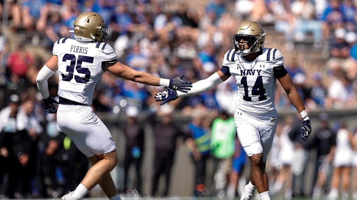 Oct 5, 2024; Colorado Springs, Colorado, USA; Navy Midshipmen safety Jaxson Campbell (14) reacts with defensive end Luke Pirris (35) after a play in the fourth quarter against the Air Force Falcons at Falcon Stadium. Mandatory Credit: Isaiah J. Downing-Imagn Images