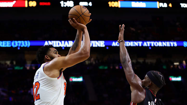 Oct 30, 2024; Miami, Florida, USA; New York Knicks center Karl-Anthony Towns (32) shoots the basketball over Miami Heat forward Jimmy Butler (22) during the fourth quarter at Kaseya Center. Mandatory Credit: Sam Navarro-Imagn Images