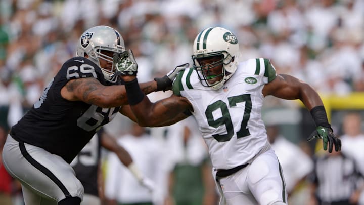 Sep 7, 2014; East Rutherford, NJ, USA; New York Jets linebacker Calvin Pace (97) tries to get past Oakland Raiders tackle Khalif Barnes (69) at MetLife Stadium. The Jets defeated the Raiders 19-14. Mandatory Credit: Kirby Lee-Imagn Images