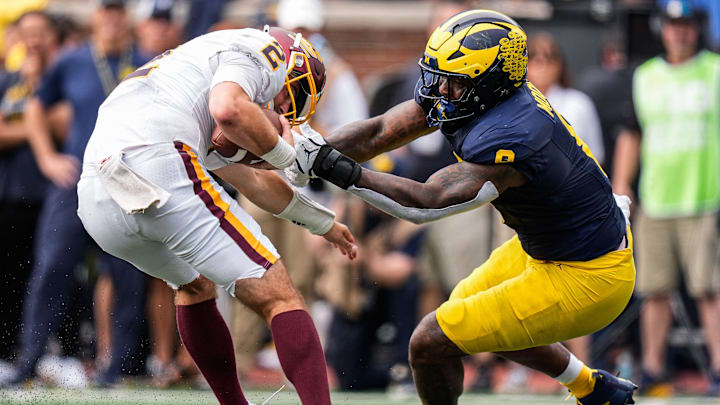 Michigan edge Derrick Moore (8) tackles Central Michigan quarterback Joe Labas (2) during the second half at Michigan Stadium in Ann Arbor on Saturday, Sept. 13, 2025. Michigan edge Derrick Moore (8) tackles Central Michigan quarterback Joe Labas (2) during the second half at Michigan Stadium in Ann Arbor on Saturday, Sept. 13, 2025.