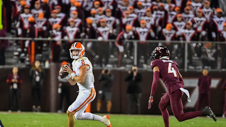 Nov 9, 2024; Blacksburg, Virginia, USA;  Clemson Tigers quarterback Cade Klubnik (2) scrambles looking for a receiver while being pursued by Virginia Tech Hokies cornerback Mansoor Delane (4) during the third quarter at Lane Stadium. Mandatory Credit: Brian Bishop-Imagn Images