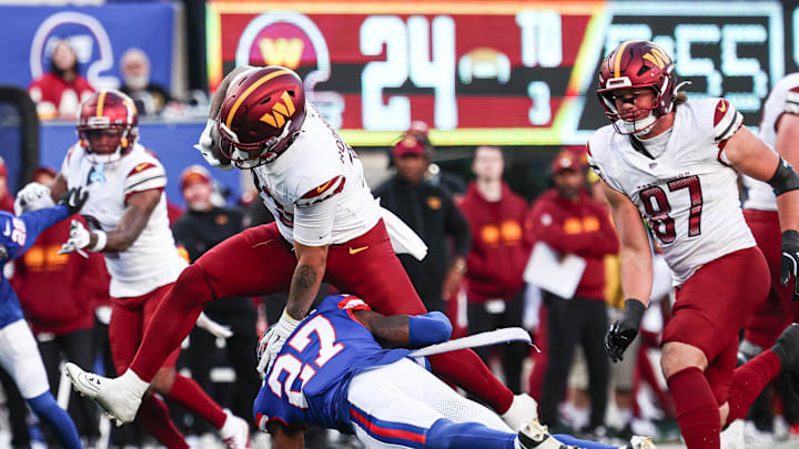 Nov 3, 2024; East Rutherford, New Jersey, USA; Washington Commanders running back Chris Rodriguez Jr. (23) is tackled by New York Giants safety Jason Pinnock (27) during the second half at MetLife Stadium. Mandatory Credit: Vincent Carchietta-Imagn Images Nov 3, 2024; East Rutherford, New Jersey, USA; Washington Commanders running back Chris Rodriguez Jr. (23) is tackled by New York Giants safety Jason Pinnock (27) during the second half at MetLife Stadium. Mandatory Credit: Vincent Carchietta-Imagn Images
