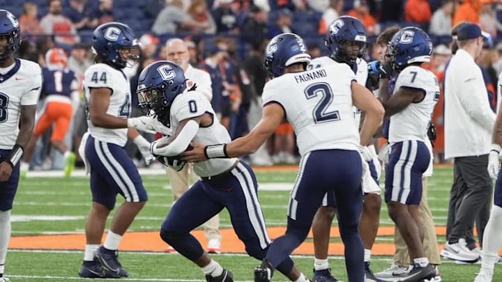 Sep 6, 2025; Syracuse, New York, USA; UConn Huskies running back Cam Edwards (0) and quarterback Joe Fagnano (2) warm up prior to a game against the Syracuse Orange at JMA Wireless Dome. Mandatory Credit: Gregory Fisher-Imagn Images