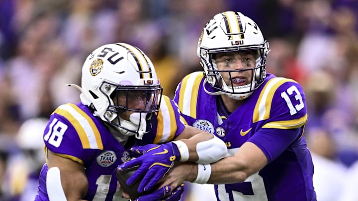 Dec 31, 2024; Houston, TX, USA; LSU Tigers quarterback Garrett Nussmeier (13) hands off the ball to running back Josh Williams (18) during the first half against the Baylor Bears at NRG Stadium. The Tigers defeat the Bears 44-31. Mandatory Credit: Maria Lysaker-Imagn Images Dec 31, 2024; Houston, TX, USA; LSU Tigers quarterback Garrett Nussmeier (13) hands off the ball to running back Josh Williams (18) during the first half against the Baylor Bears at NRG Stadium. The Tigers defeat the Bears 44-31. Mandatory Credit: Maria Lysaker-Imagn Images